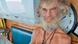 A white bearded man smiles A white bearded man smiles