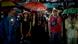 People in raingear holding umbrellas at a protest People in raingear holding umbrellas at a protest