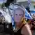 A demonstrator wearing a mask depicting Israeli Prime Minister Benjamin Netanyahu