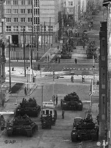 U.S. Army tanks, foreground, at Checkpoint Charlie, and Soviet Army tanks, opposite, face each other in the most dangerous of several crises at the Friedrichstrasse checkpoint in Berlin during the Cold War, Oct. 28, 1961. The armor remained in position for more than 16 hours at one of the few crossing points in the wall that divided Communist East Berlin and West Berlin. The Russians retreated to a ruined royal palace while the Americans moved to a bombed site. (AP Photo/Kreusch)
