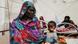 Salwa Ibraheem Hassan, a Sudanese woman who fled the conflict in Geneina, in Sudan's Darfur region, sits beside her daughter Mihrab Abdullah who is suffering from malnutrition Salwa Ibraheem Hassan, a Sudanese woman who fled the conflict in Geneina, in Sudan's Darfur region, sits beside her daughter Mihrab Abdullah who is suffering from malnutrition