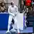 Ukrainian fencer Olga Kharlan removes her electronic tether after defeating Russian opponent Anna Smirnova at the world fencing championships in Milan, Italy 