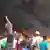 Protesters outside a large fire in Niamey, Niger