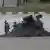 7月26日台湾“汉光”年度演习期间，一对台军士兵正在桃园国际机场的一辆军车旁走过，车上安装有多枚美制“毒刺”便携防空导弹发射装置