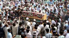 Relatives and mourners carry the casket of a victim who was killed in Sunday's suicide bomber attack in the Bajur district of Khyber Pakhtunkhwa, Pakistan, Monday, July 31, 2023. Pakistan held funerals on Monday for victims of a massive suicide bombing that targeted a rally of a pro-Taliban cleric the previous day. (AP Photo/Mohammad Sajjad)