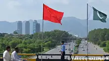 A policeman stands guard under the national flags of China and Pakistan along a road ahead of the visit of Chinese Vice Premier He Lifeng, in Islamabad on July 30, 2023. Lifeng was due in the Pakistan capital on July 30 to mark the 10th anniversary of a mega economic plan that is the cornerstone of Beijing's Belt and Road Initiative. (Photo by Farooq NAEEM / AFP)