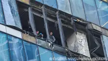 01/08/2023 Members of security services investigate a damaged office building in the Moscow City following a reported Ukrainian drone attack in Moscow Russia, August 1, 2023. REUTERS/Evgenia Novozhenina