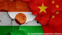 flags of Niger and China painted on cracked wall