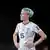 Megan Rapinoe stands on the pitch arms akimbo