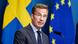 A suit-wearing, bespectacled man, Swedish Prime Minister Ulf Kristersson, speaks at a press conference as Swedish and EU flags hang behind him A suit-wearing, bespectacled man, Swedish Prime Minister Ulf Kristersson, speaks at a press conference as Swedish and EU flags hang behind him