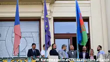 The Romani flag, right, being hoisted at the New Town Hall on the occasion of International Day of Remembrance of the Roma Victims of the Holocaust, on August 2, 2023, in Prague, Czech Republic, in attendance of Prague Mayor Bohuslav Svoboda, 4th from right. (CTK Photo/Katerina Sulova)