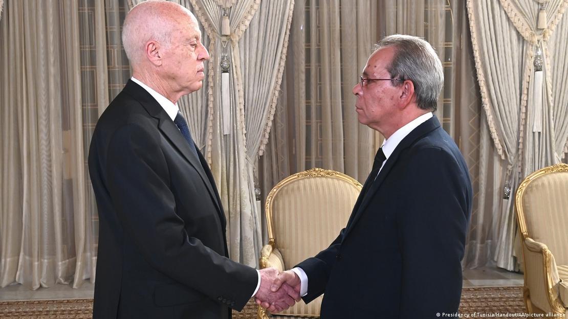 Tunisian President Kais Saied (left) and Ahmed Hachani shaking hands
