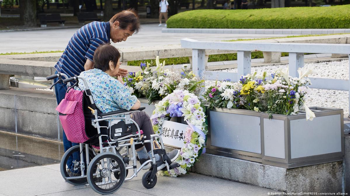 People pray for the atomic bombing victims in front of the Cenotaph at the Peace Memorial Park in Hiroshima City.