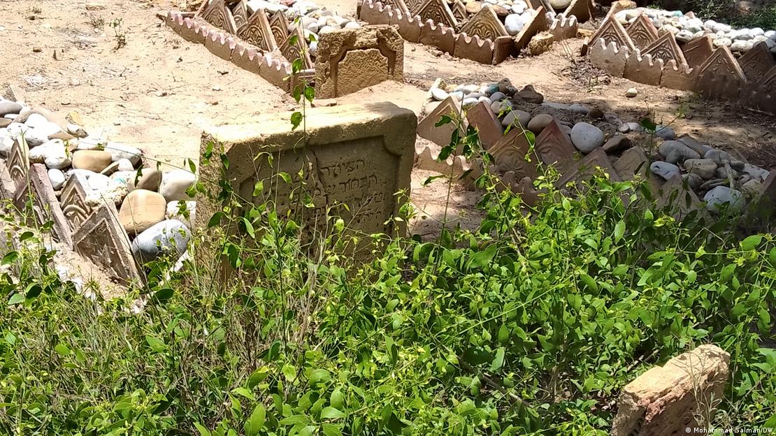 A Jewish gravestone overgrown with grass in Karachi