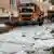 A snowplow clears a layer of thick ice from a street in Reutlingen, Germany on August 4, 2023