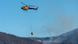 A helicopter douses water on a forest fire near Portbou, Catalonia, Spain on August 5, 2023 A helicopter douses water on a forest fire near Portbou, Catalonia, Spain on August 5, 2023