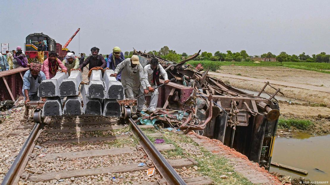 Railway workers repair damaged track near Nawabshah, Sindh, Pakistan