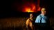 Two men watch wildfires near a field in Aljezur, Algarve, Portugal Two men watch wildfires near a field in Aljezur, Algarve, Portugal