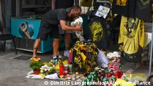 ATHENS, GREECE - AUGUST 08: A man lays flowers in the memory of 29-year-old Greek fan died during the overnight clashes between rival supporters in Nea Filadelfeia, Athens, Greece on August 08, 2023. European governing soccer body UEFA postponed the Champions League qualifying game between AEK Athens and Dinamo Zagreb of Croatia after the incident. Eight fans were injured while Greek police said they made 98 arrests, mostly of Croatian supporters. Dimitris Lampropoulos / Anadolu Agency