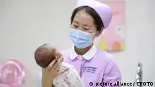 HUAI'AN, CHINA - JANUARY 13, 2023 - A nurse helps a newborn bathe in Huaian Maternal and Child Health Hospital, East China's Jiangsu province, Jan 13, 2023. According to data released by the National Bureau of Statistics on January 17, 2023, China's population reached 1411.175 million at the end of 2022, 850,000 fewer than at the end of the previous year. In 2022, 9.56 million people were born, with a birth rate of 6.77 per thousand. 10.41 million people died, with a mortality rate of 7.37 per thousand. The natural population growth rate was -0.60??.