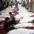 عدد من ذوي ضحايا فض اعتصام رابعة العدوية يجلسون بجانب جثامين ذويهم