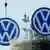 Workers attach logos of German carmaker Volkswagen to a tower in Hanover, northern Germany