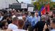 People hold placards and Albanian and Kosovar flags during a protest as two police officers look on, Prizren, Kosovo, August 11, 2023 People hold placards and Albanian and Kosovar flags during a protest as two police officers look on, Prizren, Kosovo, August 11, 2023