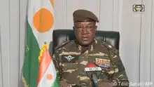 This video frame grab image obtained by AFP from ORTN - Télé Sahel on July 28, 2023 shows General Abdourahamane Tiani, Niger’s new strongman, speaking on national television and reads a statement as President of the National Council for the Safeguarding of the Fatherland, after the ouster of President-elect Mohamed Bazoum. The chief of the Presidential Guard justifies the coup by evoking the continued deterioration of the security situation in the country, as well as poor economic and social governance. (Photo by ORTN - Télé Sahel / AFP)