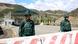 Two soldiers standing behind a road block at a remote crossing