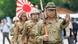 Men dressed in imperial army uniforms march Men dressed in imperial army uniforms march