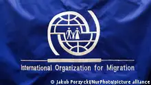 International Organization for Migration logo is seen during the job fair, organized mainly for Ukrainian refugees, in Krakow, Poland on December 8, 2022. (Photo by Jakub Porzycki/NurPhoto)