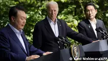 US President Joe Biden (C), Japanese Prime Minister Fumio Kishida (R), and South Korean President Yoon Suk Yeol speak during a press conference at the Camp David Trilateral Summit at Camp David in Maryland on August 18, 2023. (Photo by Kent Nishimura / AFP)