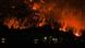 The McDougall Creek wildfire burns on the mountainside above houses in West Kelowna The McDougall Creek wildfire burns on the mountainside above houses in West Kelowna