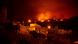 Fire lighting up the night sky behind some houses in the Guimar valley in Tenerife Fire lighting up the night sky behind some houses in the Guimar valley in Tenerife