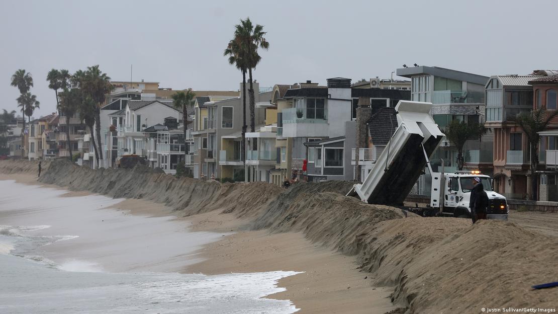 A sand berm in front of homes in Long Beach, California