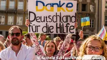 August 18, 2023, Munich, Bavaria, Germany: Ukrainians attend a rally by Chancellor Olaf Scholz to than Germany and Germans for their support of Ukraine against Russian aggression. Some of the groups asked to not forget the Ukrainians and also asked the Chancellor to close the skies and deliver Taurus weapons to Ukraine. Accompanying the SPD-BayernÃ¢â¬â¢s Landtag Spitzenkandidat Florian von Brunn, German Chancellor Olaf Scholz made an appearance in support of Florian von Brunn and others from the SPD Bayern party ahead of the Bavarian Landtag elections in a few weeks. Chancellor Scholz also reiterated his support for Ukraine to the cheers of many Ukrainians, the supporters of Ukraine, one injured defender. Among the many people at Marienplatz were many from the Querdenken, Reichsbuerger, conspiracy, anti-democratic pacifism-extremism groups, and far-right groups who banded together to try and create enough noise to disturb the Chancellor. (Credit Image: Â© Sachelle Babbar/ZUMA Press Wire