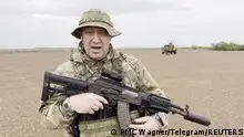 Yevgeny Prigozhin, chief of Russian private mercenary group Wagner, gives an address in camouflage and with a weapon in his hands in a desert area at an unknown location, in this still image taken from video possibly shot in Africa and published August 21, 2023. Courtesy PMC Wagner via Telegram via REUTERS ATTENTION EDITORS - THIS IMAGE WAS PROVIDED BY A THIRD PARTY. NO RESALES. NO ARCHIVES. MANDATORY CREDIT. TPX IMAGES OF THE DAY 