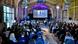 Hall full of people watching a film on a big screen. Hall full of people watching a film on a big screen.