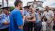 Journalist Vullnet Krasniqi (dressed in a blue T-shirt) speaks as a police officer and civilian try to restrain an angry protester, Prizren, Kosovo, August 11, 2023