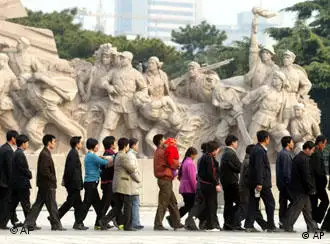 ** TO GO WITH THE STORY SLUGGED CHINA THE GREAT PARADOX ** People walk past statues of communist revolutionaries as they file into the mausoleum of late leader Mao Zedong in Beijing's Tiananmen Square, Oct. 29, 2002. As it convenes a congress that is expected to install a new generation of leaders, the ruling Communist Party is trying to transform itself in order to stay relevant amid economic and social reforms that it unleashed. (AP Photo/Greg Baker)