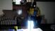 A woman drinking from a but behind a bright torchlight A woman drinking from a but behind a bright torchlight
