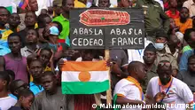 Nigeriens gather a month since coup, in support of the putschist soldiers and to demand French ambassador to leave, in the capital Niamey, Niger August 26, 2023. The sign reads Down ECOWAS, Down France. REUTERS/Mahamadou Hamidou NO RESALES. NO ARCHIVES 