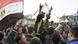An Egyptian protester perched on a lamp post in Cairo An Egyptian protester perched on a lamp post in Cairo