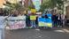 Protesters stand in the middle of a brick street in the Hague, Netherlands holding up signs and Ukrainian flags Protesters stand in the middle of a brick street in the Hague, Netherlands holding up signs and Ukrainian flags
