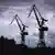 Cargo cranes in Hamburg with dark clouds in the background