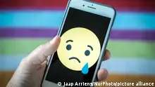 A sad face emoticon is seen on an iPhone in this photo illustration on May 25, 2018. (Photo by Jaap Arriens/NurPhoto)