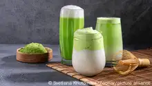 Matcha tea. Iced green tea matcha latte in glass. Green tea dalgona, whipped grean tea with milk. Healthy vegan drink, close up.