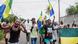 People carrying Gabon's flags celebrate on a street.