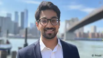 Portrait of Swapneel Metha in front of the Brooklyn Bridge in New York City