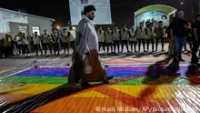 Supporters of Shiite Muslim leader Moqtada Sadr step on a LGBTQ rainbow flag, during a demonstration in Sadr City, in response to the burning of Quran in Sweden, Baghdad, Iraq, Wednesday, July 12, 2023. (AP Photo/Hadi Mizban)